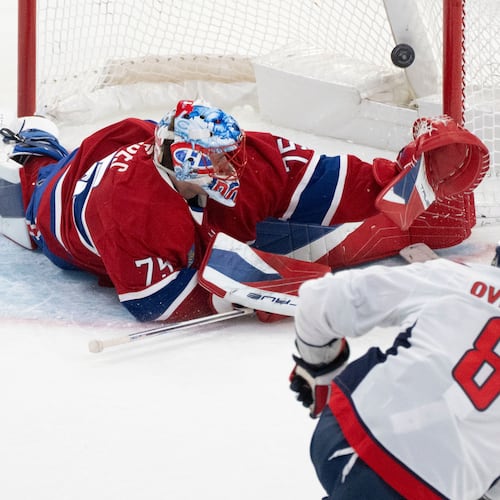 Washington Capitals' Alex Ovechkin (8) scores against Montreal Canadiens goaltender Jakub Dobes (75) during third-period NHL hockey game action in Montreal, Thursday, Nov. 20, 2025. (Christinne Muschi/The Canadian Press via AP)