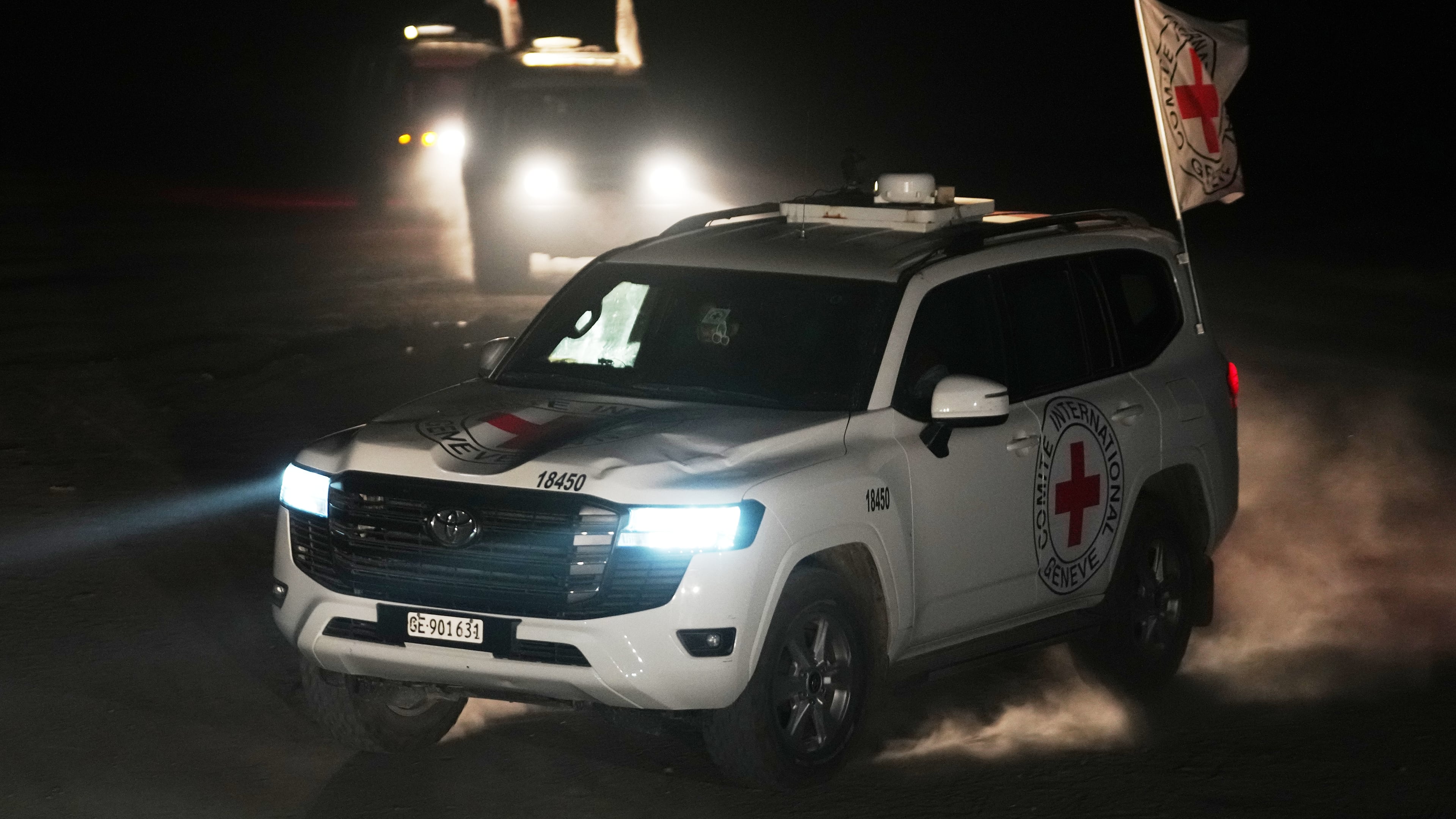 Red Cross vehicles carrying the bodies of three people believed to be deceased hostages handed over by Hamas make their way toward the border crossing with Israel, to be transferred to Israeli authorities, in Deir al-Balah, central Gaza Strip, Sunday, Nov. 2, 2025. (AP Photo/Jehad Alshrafi)