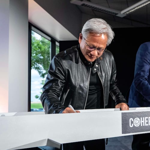Jensen Huang, left, president and CEO of Nvidia, and Jim Anderson, CEO of Coherent, sign a ceremonial construction beam before a groundbreaking ceremony for an expansion of Coherent's manufacturing facility on Tuesday, June 16, 2026, in Sherman, Texas. (AP Photo/Jeffrey McWhorter)