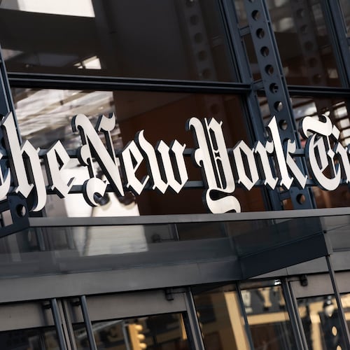 FILE - A sign for The New York Times hangs above the entrance to its building in New York, May 6, 2021. (AP Photo/Mark Lennihan, File)