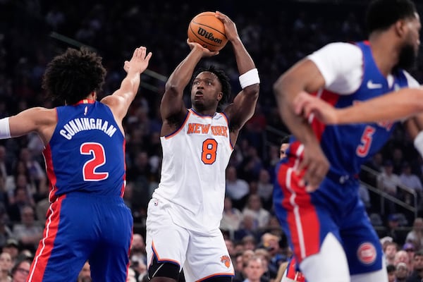 New York Knicks forward OG Anunoby (8) shoots past Detroit Pistons guard Cade Cunningham (2) during the first half of Game 1 in an NBA basketball first-round playoff series, Saturday, April 19, 2025, in New York. (AP Photo/Julia Demaree Nikhinson)