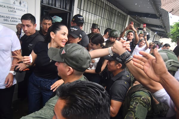 Luisa Gonzalez, presidential candidate from the Citizen Revolution party, greets supporters after voting in the presidential election runoff in Canuto, Ecuador, Sunday, April 13, 2025. (AP Photo/Ariel Ochoa)