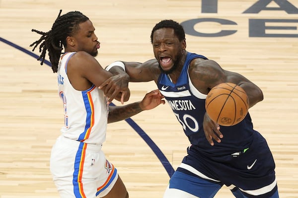 Minnesota Timberwolves forward Julius Randle (30) loses control of the ball while defended by Oklahoma City Thunder guard Cason Wallace (22) during the first half of Game 3 of the Western Conference finals of the NBA basketball playoffs, Saturday, May 24, 2025, in Minneapolis. (AP Photo/Matt Krohn)