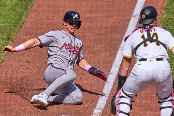 Atlanta Braves' Stuart Fairchild, left, scores the third of three runs on a three-run double by Sean Murphy off Pittsburgh Pirates pitcher Joey Wentz during the eighth inning of a baseball game in Pittsburgh, Sunday, May 11, 2025. (AP Photo/Gene J. Puskar)
