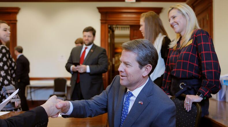 Secretary of State Brian Kemp, accompanied by his wife, Marty (right), and daughter, Amy Porter, filed his qualification papers to run for governor on March 7, 2018.  BOB ANDRES  /BANDRES@AJC.COM