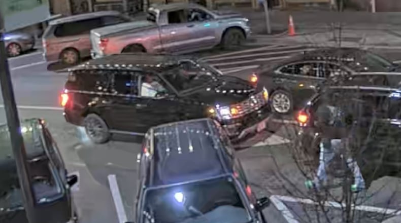 A surveillance camera in downtown Athens captured footage of a rented SUV driven by Chandler LeCroy, a recruiting analyst for the University of Georgia's football team, moments before a fatal crash on Jan. 15. A newly filed lawsuit disputes the university's public statements on events leading to the crash, which killed LeCroy and offensive lineman Devin Willock.