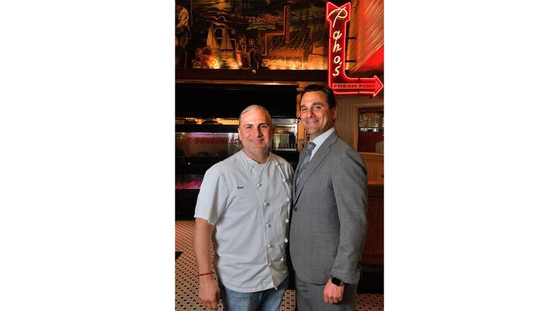 Brothers Pano I. (left) and Niko Karatassos inside the Atlanta Fish Market, which also houses the offices for the Buckhead Life Group. Contributed by Chris Hunt Photography