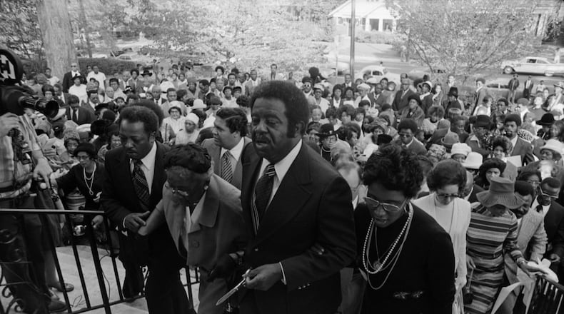 Ralph David Abernathy (cneter) and his wife Juanita (right) attend the dedication of the West Hunter Street Baptist Church in 1973.