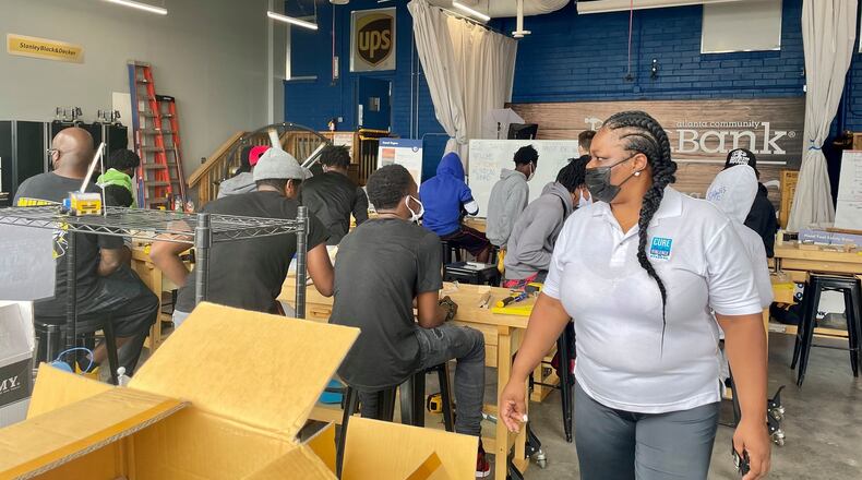 Tekesia Shields (right), a program staff member with Cure Violence in Atlanta, at an event hosted by CHRIS 180’s Cure Violence initiative Money Moves Mentorship Program. This program is for youth on probation, and teaches them new skills as they take part in community service.