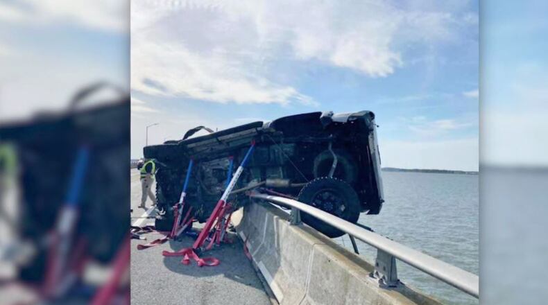 When a car nearly went off a Maryland bridge, saved only by the guardrail, an infant was ejected into Assawoman Bay. A good Samaritan immediately dove in to rescue the child. (Source: Ocean City Fire Department)