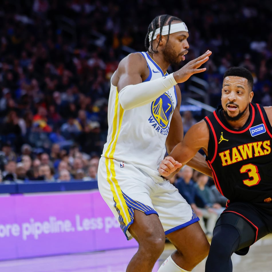 Buddy Hield (7) of the Golden State Warriors guards against CJ McCollum (3) of the Atlanta Hawks during the third quarter of an NBA basketball game in San Francisco, Sunday, Jan. 11, 2026. (Carlos Avila Gonzalez/San Francisco Chronicle via AP)