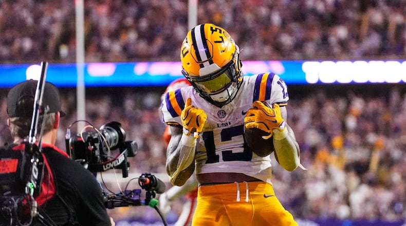 LSU running back Dilin Jones (13) celebrates his touchdown against Clemson in the second half of an NCAA college football game, Saturday, Sept. 5, 2026 in Baton Rouge, La. (AP Photo/Gerald Herbert)