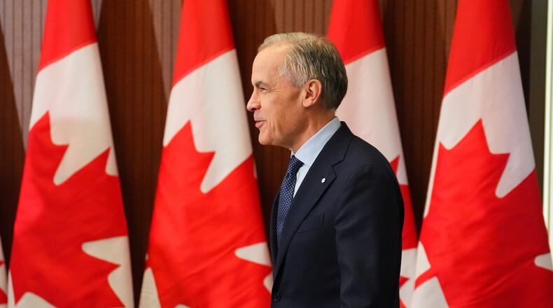 Prime Minister Mark Carney arrives for a news conference in Ottawa on Tuesday, April 14, 2026. (Sean Kilpatrick/The Canadian Press via AP)