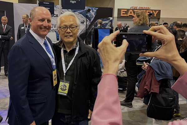 FILE - Berkshire Hathaway Vice Chairman Greg Abel poses for pictures with shareholders while touring the booths Berkshires companies set up, Friday, May 3, 2024, in Omaha, Neb. (AP Photo/Josh Funk, File)