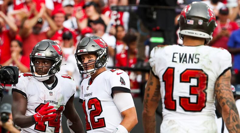 Tampa Bay Buccaneers wide receiver Chris Godwin (14), left, celebrates his touchdown catch with quarterback Tom Brady (12), who threw for five touchdowns on the day, during the fourth quarter against the Atlanta Falcons at Raymond James Stadium on Sunday, Sept. 19, 2021 in Tampa. (Dirk Shadd/Chicago Tribune/TNS)