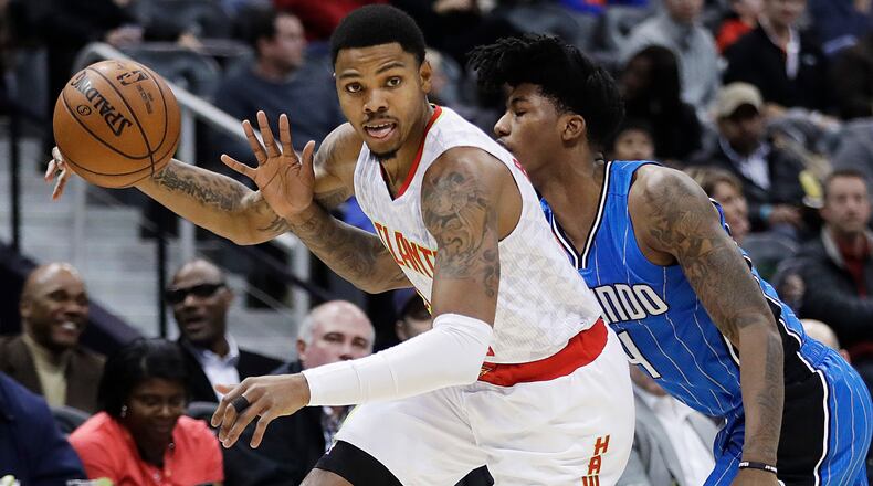 Atlanta Hawks’ Kent Bazemore, left, plays against Orlando Magic’s Elfrid Payton in the first quarter of an NBA basketball game in Atlanta, Tuesday, Dec. 13, 2016. (AP Photo/David Goldman)