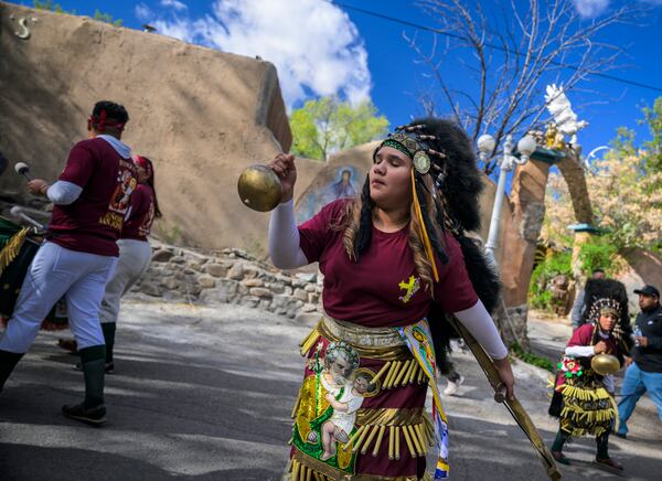 Genesys Arellanes, 11, along with members of the Danza Señor San Jose dance group performs near El Santuario De Chimayo in Northern New Mexico on Good Friday, April 18, 2025. Chimayo, N.M. (AP Photo/Roberto E. Rosales)