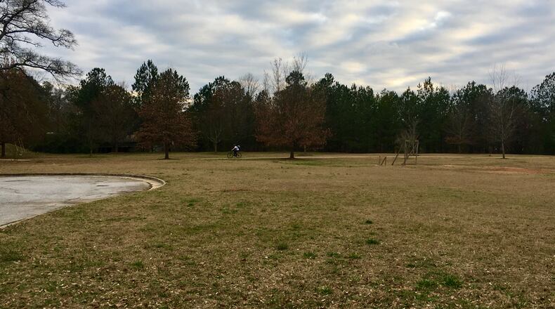 This is a portion of the property that could become an Avondale Estates development with 35 townhomes. The cul-de-sac is Hobbs Street, which according to premlinary plans would be extended and bend to the right, ending at Wells St. (not shown). The homes would front Hobbs, Wells and the Atlanta-Stone Mountain trail (in the background with cyclist). Years ago this was the site of the original Avondale High School. Bill Banks for the AJC