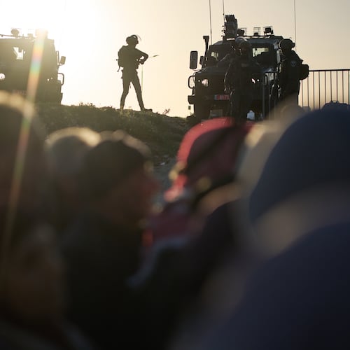Israeli soldiers stand guard as Palestinian worshippers line up to pass through the Israeli military Qalandia checkpoint between the West Bank city of Ramallah and Jerusalem on their way to attend Friday prayers at Al-Aqsa Mosque during the Muslim holy month of Ramadan, Friday, Feb. 20, 2026. (AP Photo/Leo Correa)