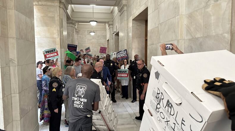 FILE - Boxes containing signatures supporting a proposed ballot measure to scale back Arkansas' abortion ban are delivered to a room in the state Capitol, July 5, 2024, in Little Rock, Ark. (AP Photo/Andrew DeMillo, File)