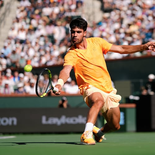 FILE - Carlos Alcaraz, of Spain, returns a shot against Daniil Medvedev, of Russia, during a semifinal match at the BNP Paribas Open tennis tournament, March 14, 2026, in Indian Wells, Calif. (AP Photo/Mark J. Terrill, File)
