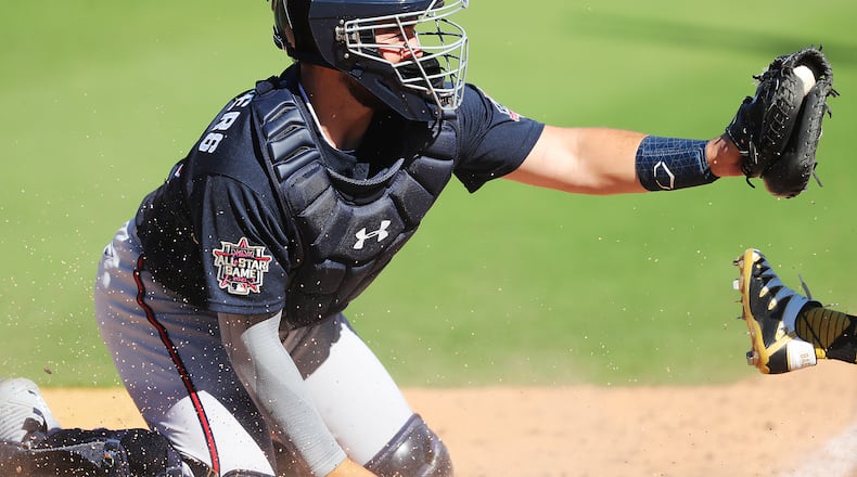 030421 Bradenton: Atlanta Braves catcher Shea Langeliers holds on to the ball making the tag on Pittsburgh Pirates Ji-hwan Bae at homeplate for the out during the sixth inning of a MLB spring training baseball game at LECOM Park on Thursday, March 4, 2021, in Bradenton.   “Curtis Compton / Curtis.Compton@ajc.com”