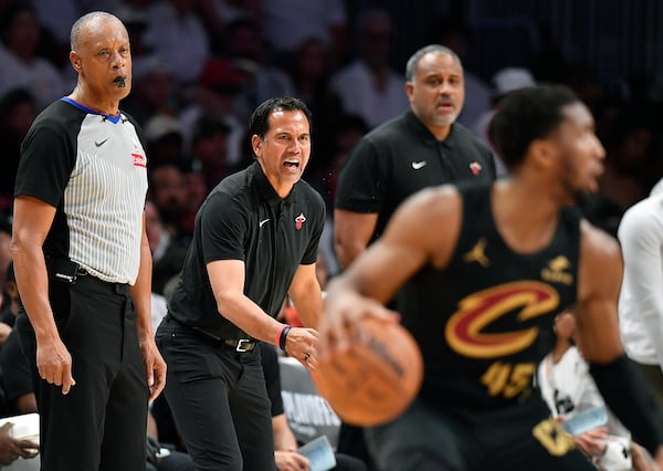 Miami Heat coach Erik Spoelstra screams instructions to his players as Cleveland Cavaliers guard Donovan Mitchell (45) dribbles during the first half in Game 3 of an NBA basketball first-round playoff series, Saturday, April 26, 2025, in Miami. (AP Photo/Michael Laughlin)