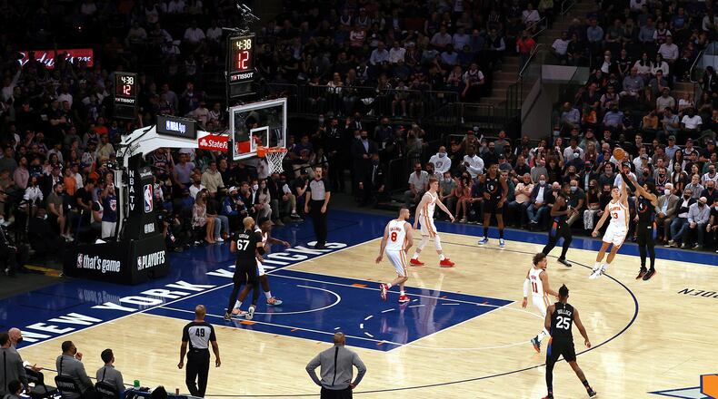 New York Knicks' Derrick Rose (4) makes a 3-point shot as Atlanta Hawks' Bogdan Bogdanovic (13) defends during the fourth quarter of Game 2 in an NBA basketball first-round playoff series Wednesday, May 26, 2021, in New York. (Elsa/Pool Photo via AP)