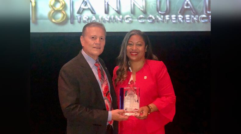 LaGrange Police Department Chief Louis Dekmar presents Natalie Ammons with the 2018 National Member of the Year award from the National Organization of Black Law Enforcement Executives. (Credit: Natalie Ammons)