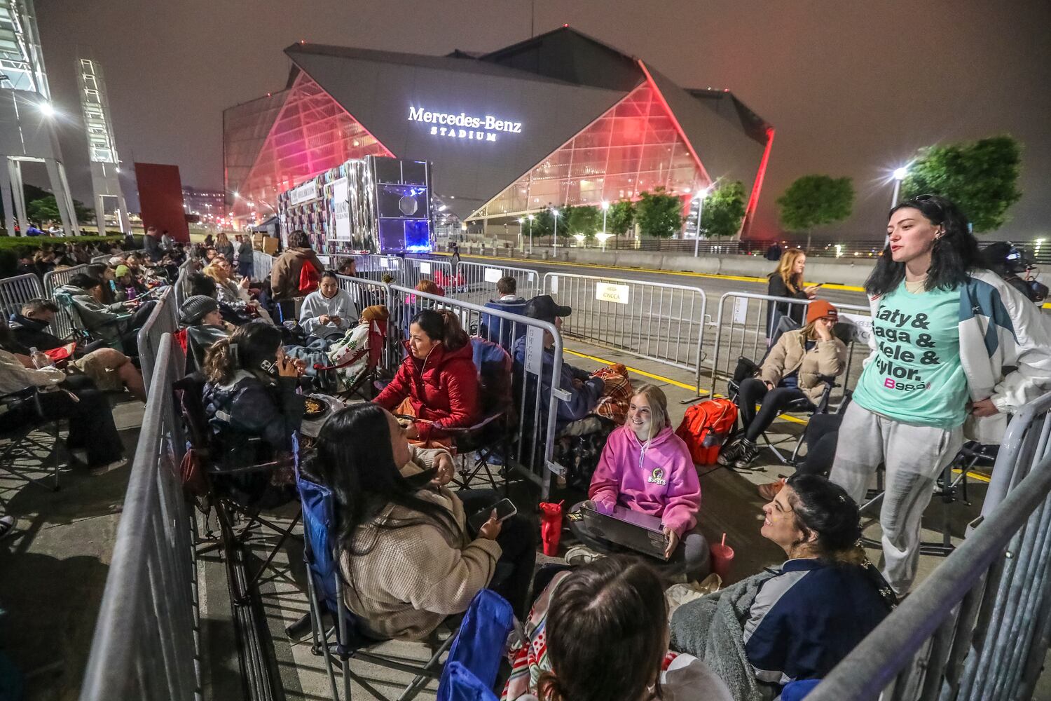 Taylor Swift fans braved cooler morning temperatures and drizzle while they waited in line before daybreak at the Georgia World Congress Center International Plaza outside Mercedes-Benz Stadium to buy official Swift merchandise on Thursday, April 27, 2023. Merchandise for Swift’s Eras Tour, which kicks off Friday for a three-night stop at the Benz, went on sale at the International Plaza outside the stadium Thursday. (John Spink / John.Spink@ajc.com)