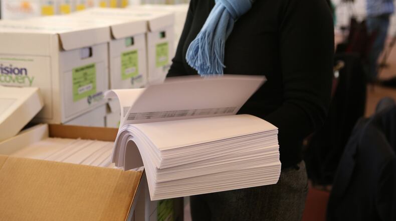 February 9, 2017, Atlanta, Georgia - A reporter reviews a portion of the more than 1.4 millions documents released in February 2017 in the Atlanta City Hall corruption investigation. (HENRY TAYLOR / HENRY.TAYLOR@AJC.COM)