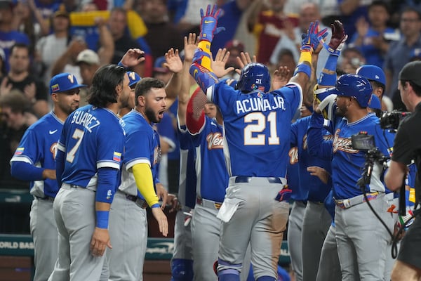 Ronald Acuña Jr. celebrates a World Baseball Classic home run with his fellow Venezuelans.