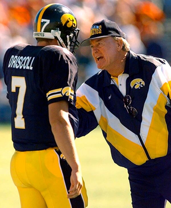 Iowa coach Hayden Fry encourages quarterback Ryan Driscoll during the second quarter of a game against Iowa State on Sept. 14, 1996.