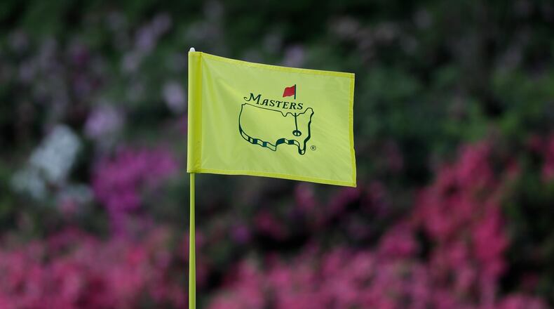 In this April 11, 2019, file photo, the flag on the 13th hole blows in the wind during the first round for the Masters golf tournament in Augusta, Ga. Augusta National decided Friday, March 13, 2020, to postpone the Masters because of the spread of the coronavirus. Club chairman Fred Ridley says he hopes postponing the event puts Augusta National in the best position to host the Masters and its other two events at some later date. Ridley did not say when it would be held.(AP Photo/David J. Phillip, Fil)