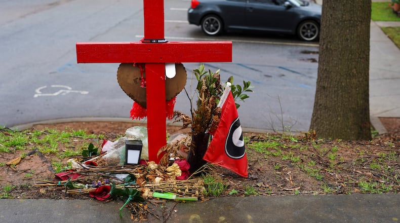 A memorial honoring the site of the car crash that ended the lives of Georgia offensive lineman, Devin Willock, 20, and UGA recruiting analyst, Chandler LeCroy, 24, sits at the intersection of Barnett Shoals and Stroud roads, east of downtown Athens, Georgia, on Thursday, March 2, 2023. (Olivia Bowdoin / AJC).