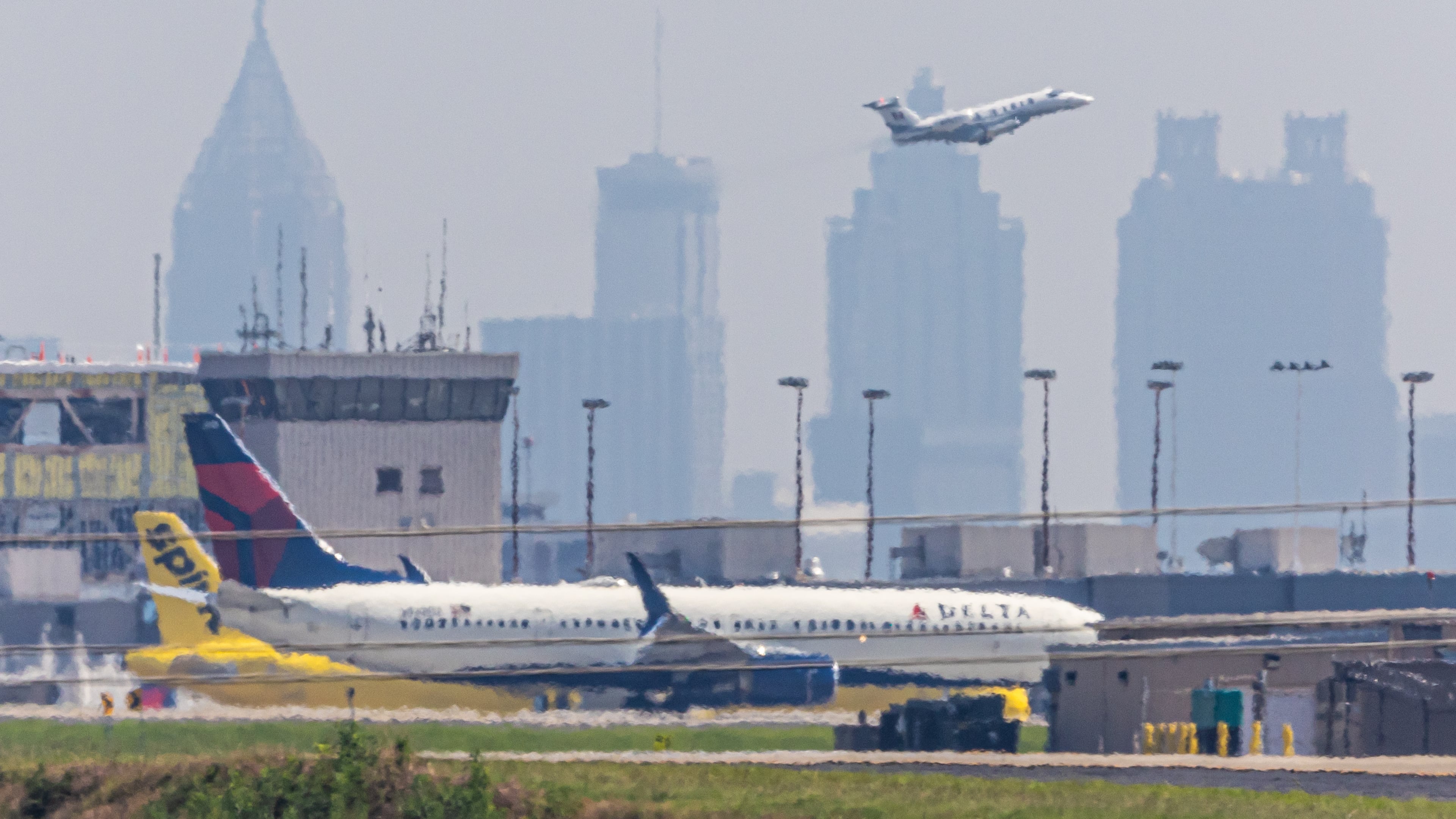 The Atlanta skyline is shrouded in smog behind Hartsfield-Jackson Atlanta International Airport on June 12, 2024 (File/AJC)