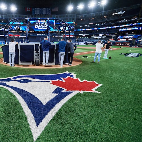 The Seattle Mariners gather around the cage during batting practice, Saturday, Oct. 18, 2025, in Toronto, ahead of Sunday's Game 6 in baseball's American League Championship Series against the Toronto Blue Jays. (Sammy Kogan/The Canadian Press via AP)