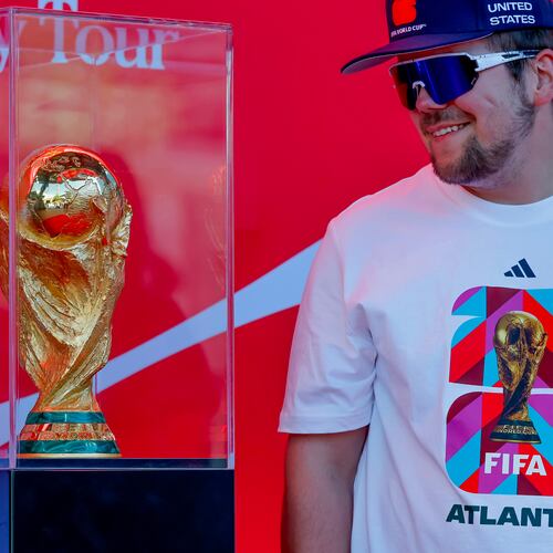 Soccer fan Joseph Pozdnakov has his photo taken during the FIFA World Cup Trophy Tour outside Truist Park before the Atlanta Braves host the Chicago Cubs in a baseball game, Thursday, May 14, 2026, in Atlanta. Eight FIFA World Cup soccer matches will be played in Atlanta.(AP Photo/Erik S. Lesser)