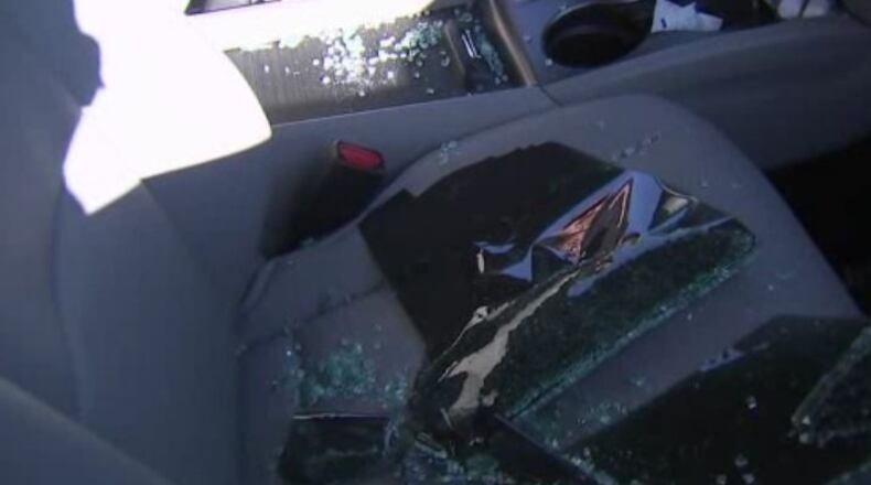 Shattered glass sits in a vehicle that was broken into in Paulding County.