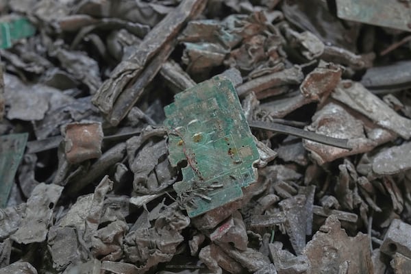 Thai officials display samples of illegally imported electronic waste from the United States which they said they seized at Bangkok Port during a press conference in Bangkok, Thailand, Wednesday, May 14, 2025. (AP Photo/Sakchai Lalit)