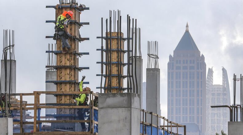 Construction workers on July 10, 2019 continued work on The Interlock, a $450 million mixed-use development in West Midtown that commercial real estate development firm, S.J. Collins Enterprises is overseeing. JOHN SPINK/JSPINK@AJC.COM