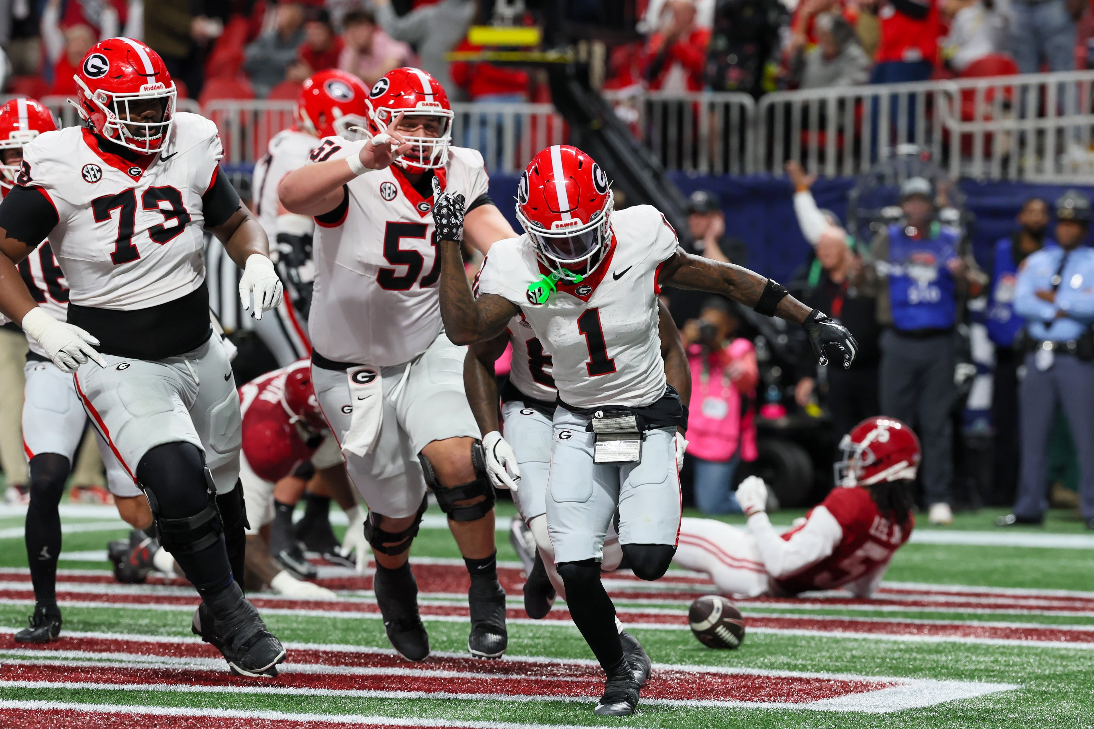 Georgia wide receiver Zachariah Branch (1) reacts after scoring a touchdown against Alabama during the fourth quarter of the SEC Championship game at Mercedes-Benz Stadium, Saturday, Dec. 6, 2025, in Atlanta. (Jason Getz / AJC)