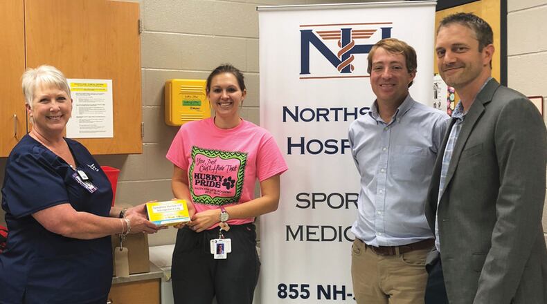Celebrating the delivery of EpiPens at Hasty Elementary School Fine Arts Academy in Canton are (from left) Cherokee County School District Lead Nurse Gwen Chambers, School Nurse Brittany Doucette, and Drs. Matthew Simmons and Stephen Rodes with the Northside Hospital Sports Medicine Network. CHEROKEE COUNTY SCHOOL DISTRICT