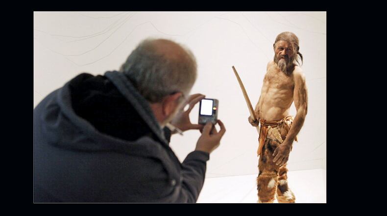 A man takes pictures of a statue representing an iceman named Oetzi, discovered on 1991 in the Italian Schnal Valley glacier, is displayed at the Archaeological Museum of Bolzano on Feb. 28, 2011 during an official presentation of the reconstrution. Based on three-dimensional images of the mummy's skeleton as well as the latest forensic technology, a model of the living Oetzi was created by Dutch experts Alfons and Adrie Kennis. (Photo: Andrea Solero/AFP/Getty Images)