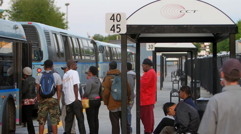 Morning rush hour commuters gather at the Cobb Community Transit in Marietta on Tuesday.