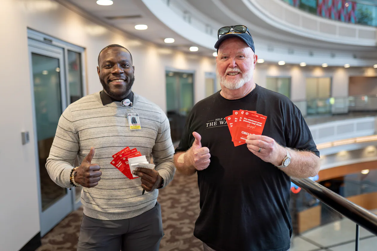 Kevin Campbell (right) brought gift cards for Clear manager Byran McCray to give to struggling TSA workers Friday (Ben Hendren for the AJC)