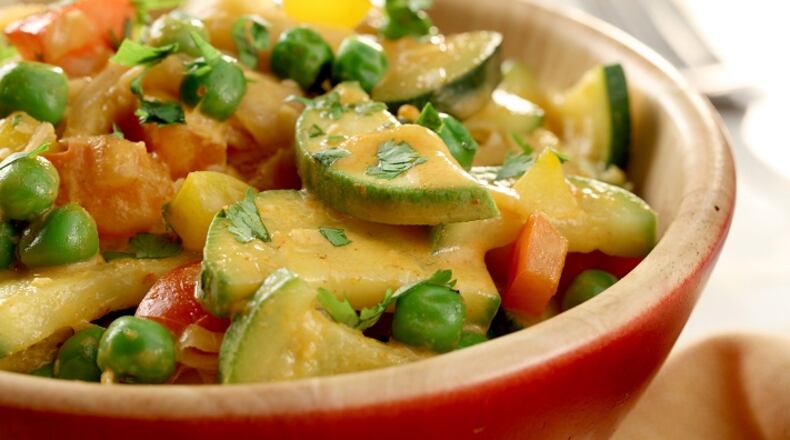 Unsweetened coconut milk mixed with Thai curry paste flavors an easy sauce for sauteed vegetables. (Michael Tercha/Chicago Tribune/TNS)