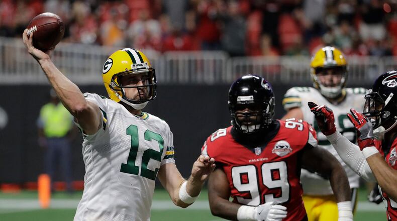 Green Bay Packers quarterback Aaron Rodgers (12) works against the Atlanta Falcons during the first of an NFL football game, Sunday, Sept. 17, 2017, in Atlanta. (AP Photo/David Goldman)