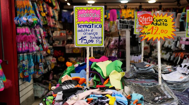 A sign offers payment via Pix, a free payment system, at a store in Rio de Janeiro, Thursday, April 16, 2026. (AP Photo/Silvia Izquierdo)