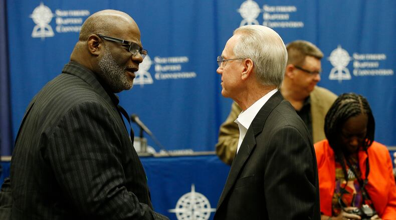 The Rev. William McKissic, left, of Arlington, Texas, shakes hands with Barrett Duke, right, chairman of the 2017 Committee on Resolutions, after McKissic's resolution to condemn "alt-right" white supremacy was voted on and passed at the Southern Baptist Convention annual meeting on Wednesday. AP Photo/Ross D. Franklin